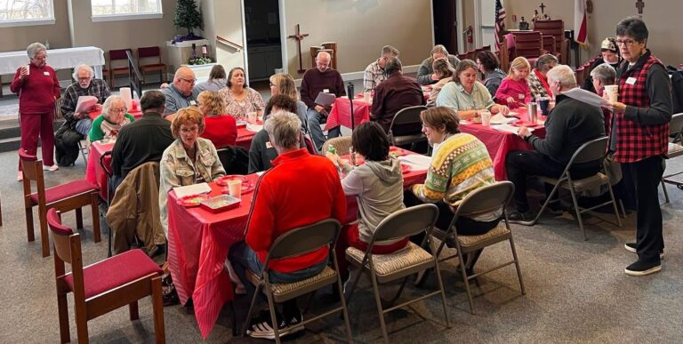 A group of people engaged in conversation at Lee's Summit Memory Cafe hosted by St. Anne's Episcopal Church outreach ministries.