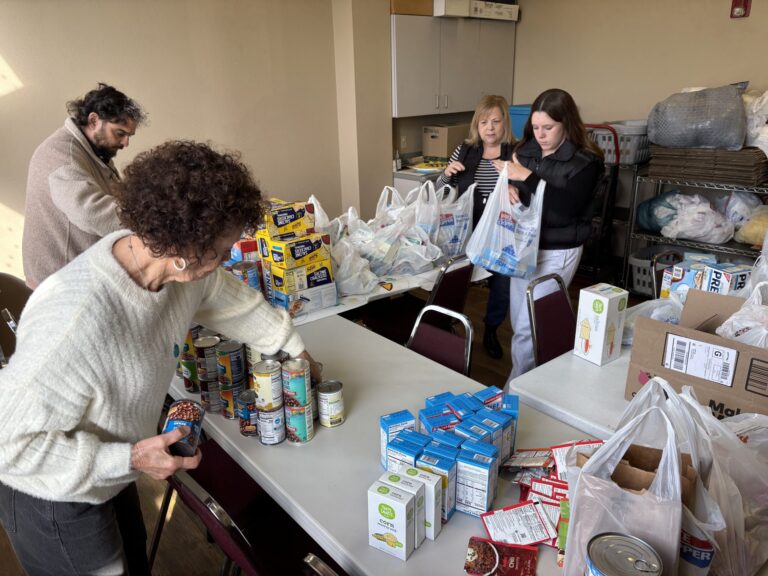 Members of St. Anne's package non-perishable items for Meals for Mustangs, an outreach ministry for St. Anne's Episcopal Church.